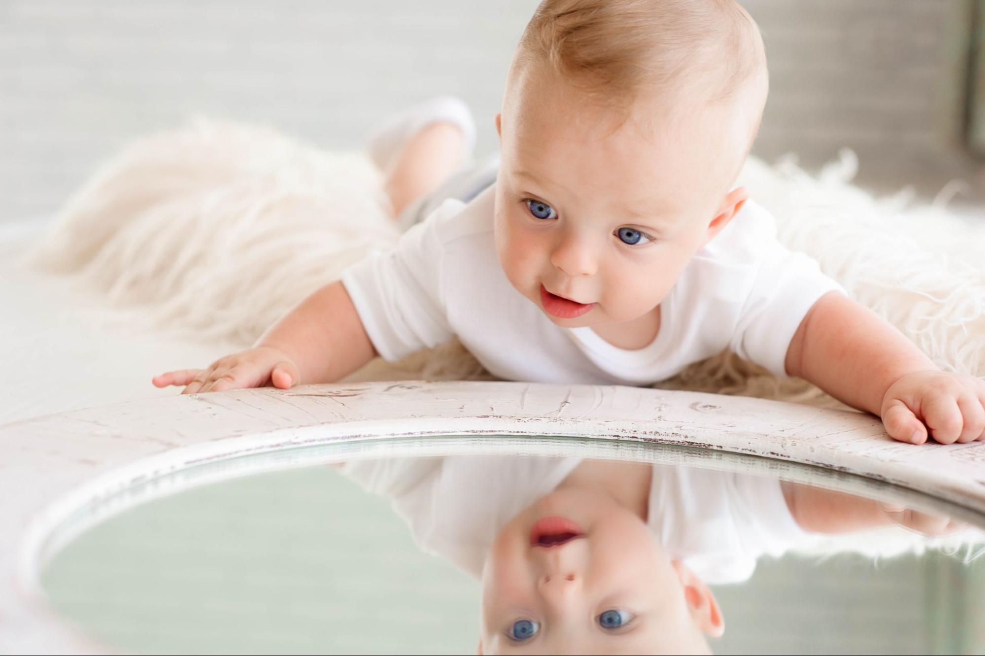 Curious baby looking at themselves in a mirror, capturing curiosity and self-discovery