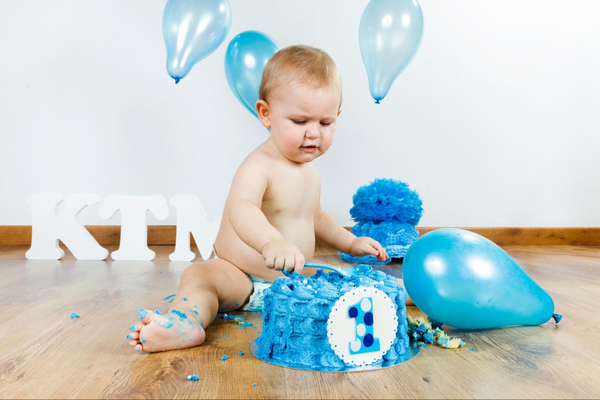 Baby with balloon backdrop, capturing whimsy and joyous celebration.