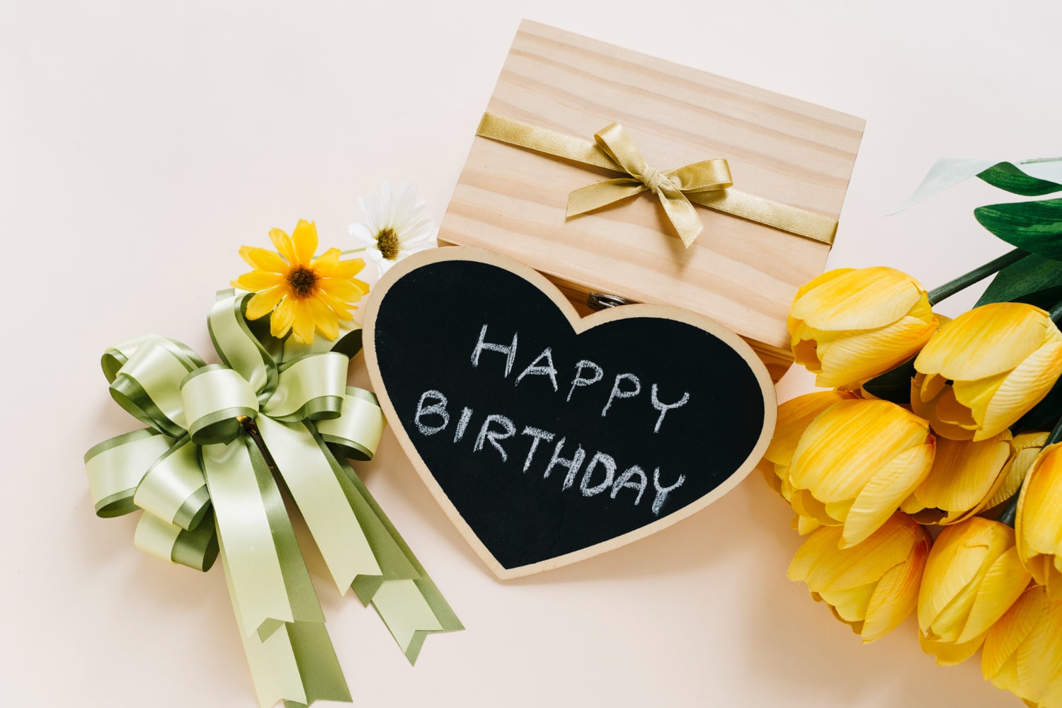 A personalized birthday gift card featuring yellow tulips and a box 
