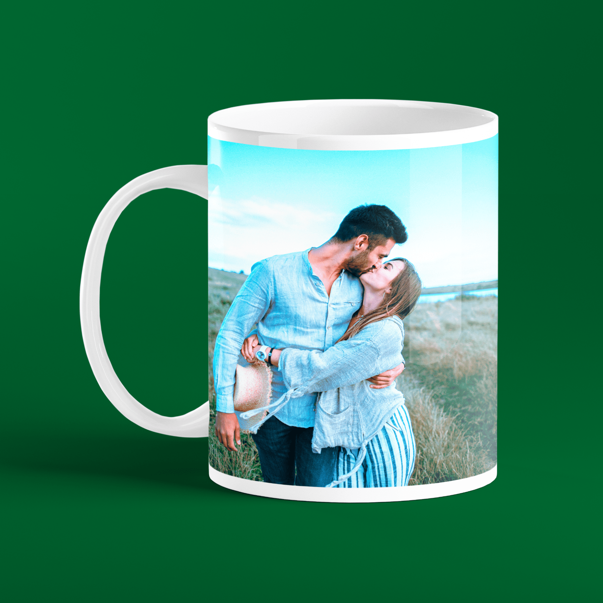 A romantic couple sharing a kiss on a customized photo mug 