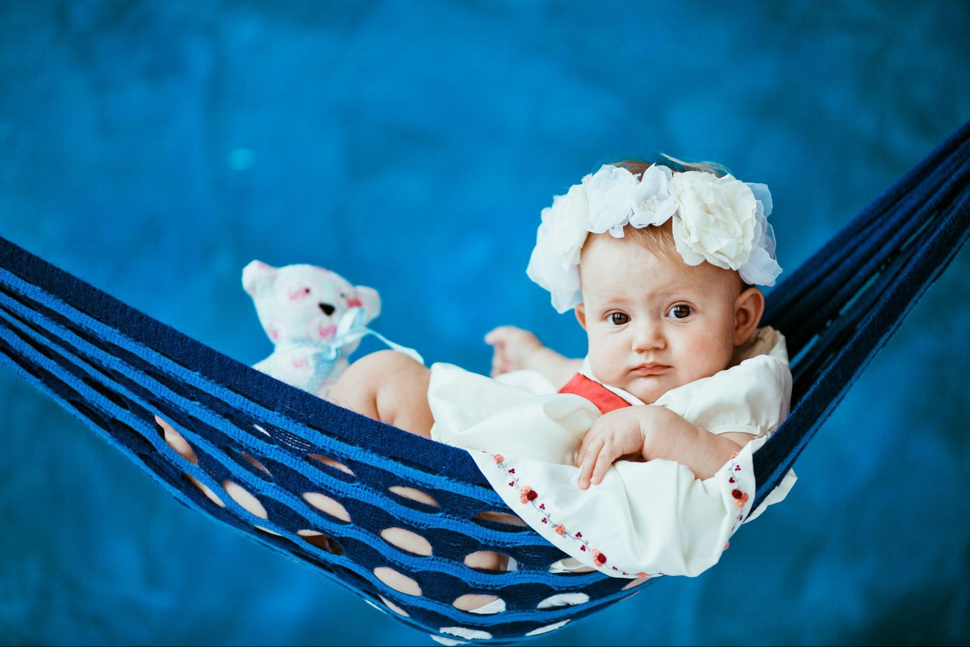 Baby enjoying a swing photoshoot outdoors during golden hour